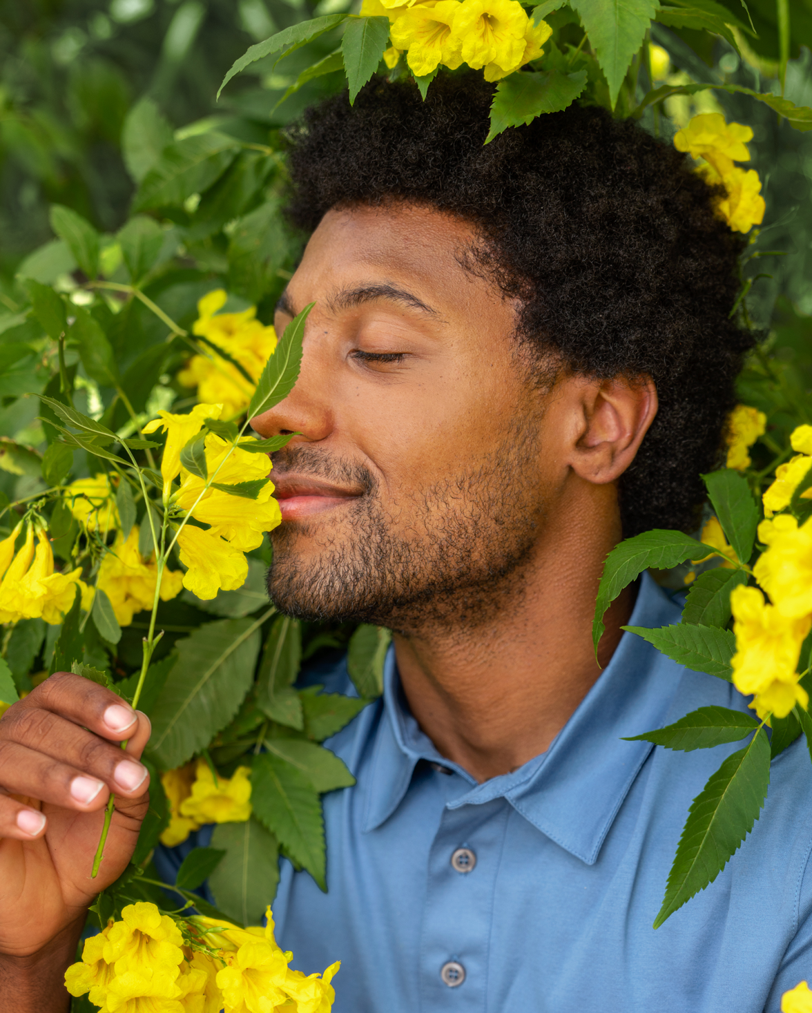 Man sniffing a flower